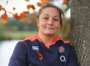 didi ambassador and England hooker Amy Cokayne leaning against a tree