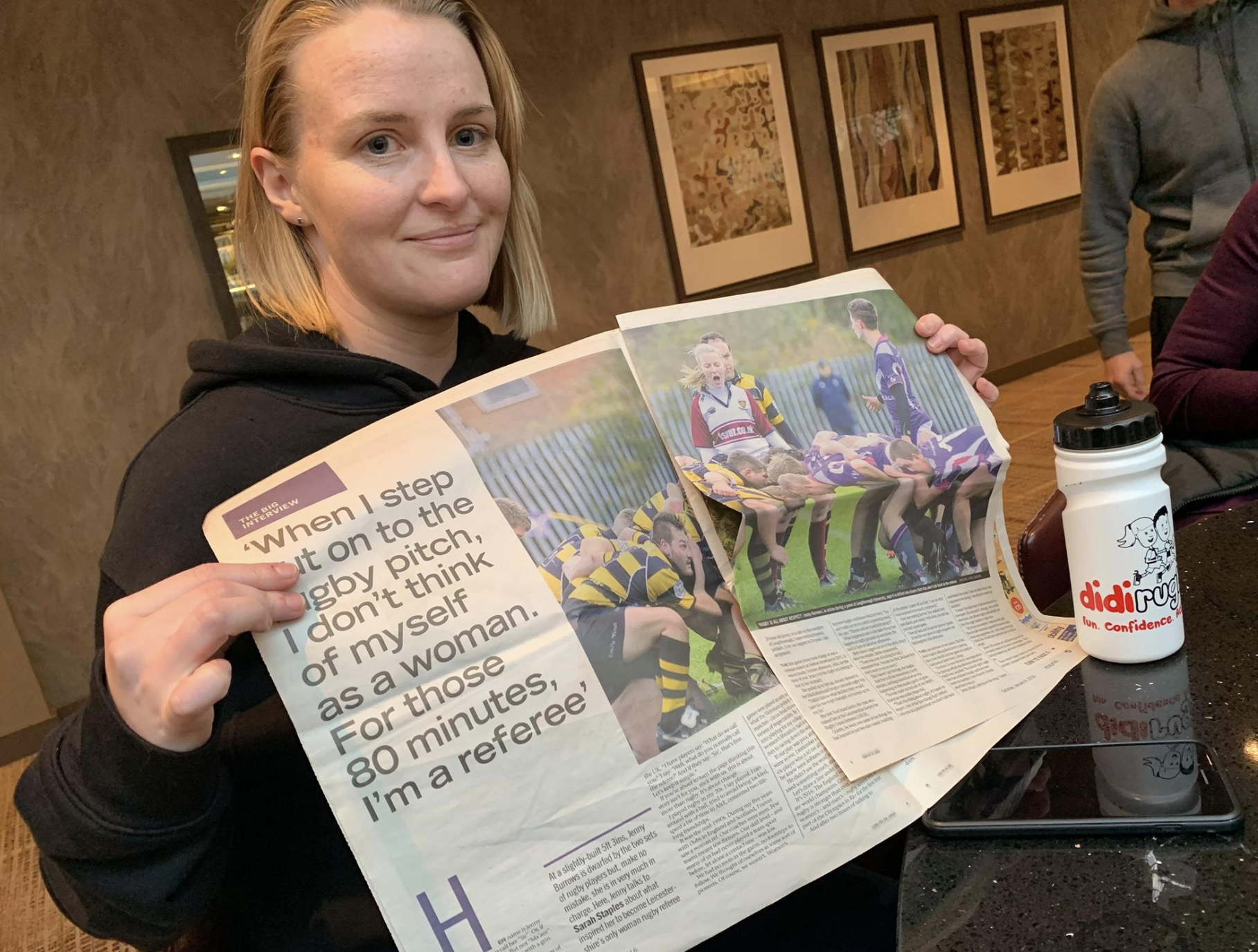 didi rugby Birstall coach Jenny Burrows holds up a newspaper featuring a story about herself