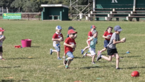 Children run around with balls in their hands at Reading Rugby Club's didi rugby session