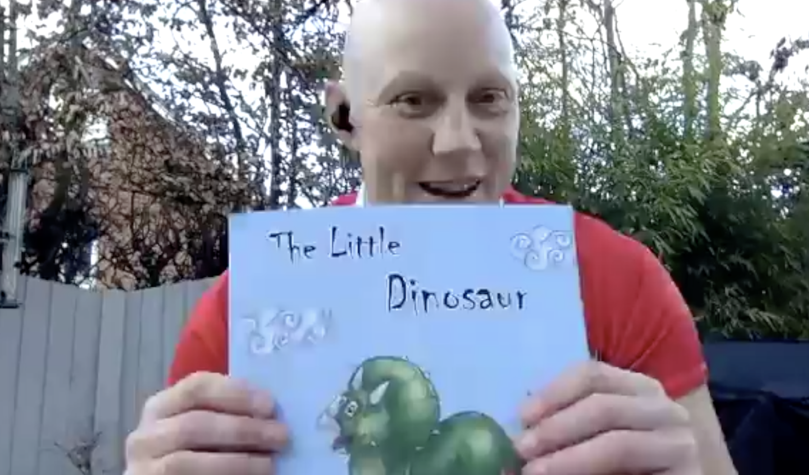 England star Heather Fisher holds up a book called The Little Dinosaur