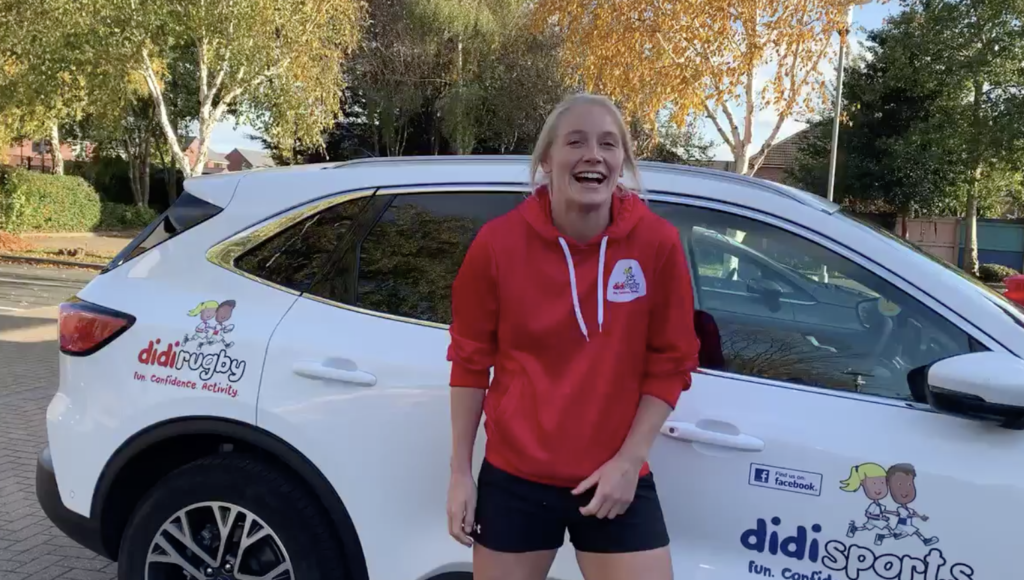 Alex Matthews, wearing didi rugby kit, laughs