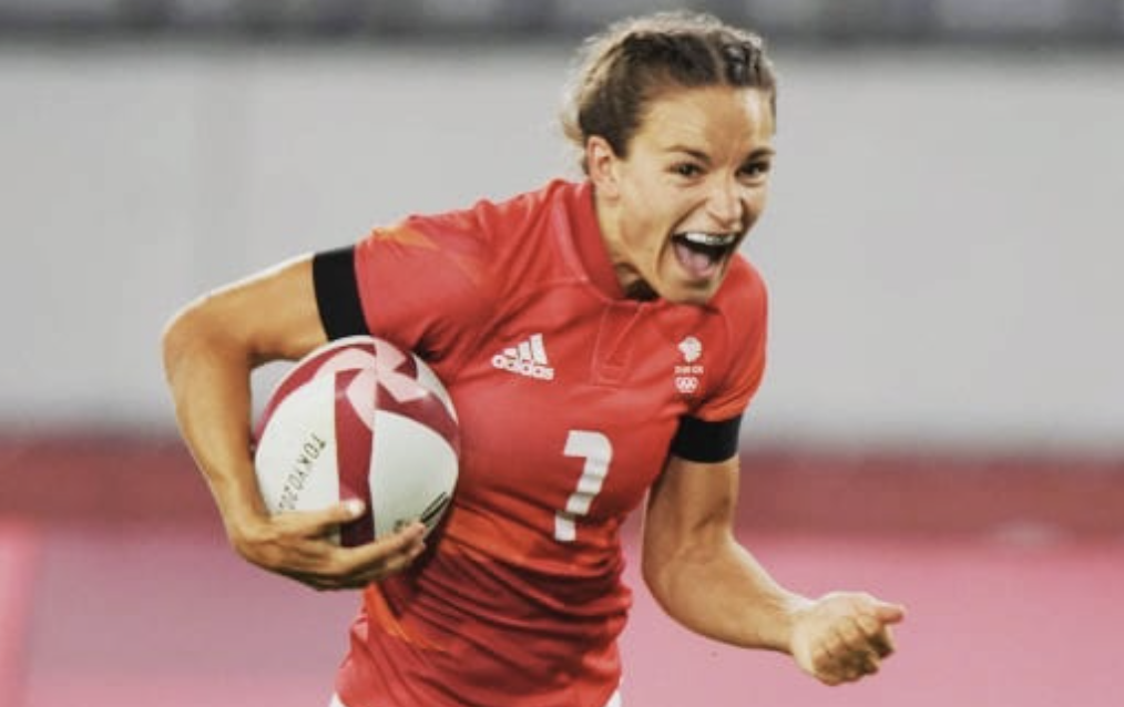 The new owner of didi rugby South Wales, Jasmine Joyce runs with the ball in a red jersey