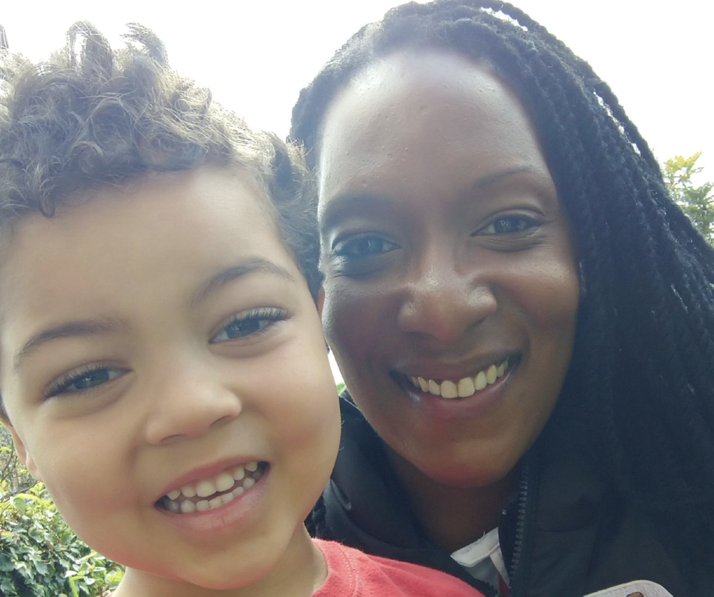 A didi rugby mother Max and her young son Nathan smile at the camera in their garden