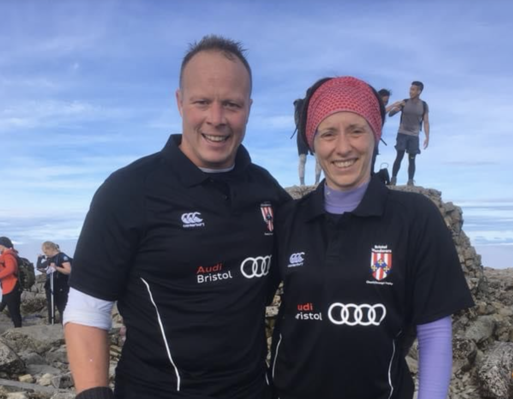 Rochelle and Simon Gully stood on a large rock at the beach.