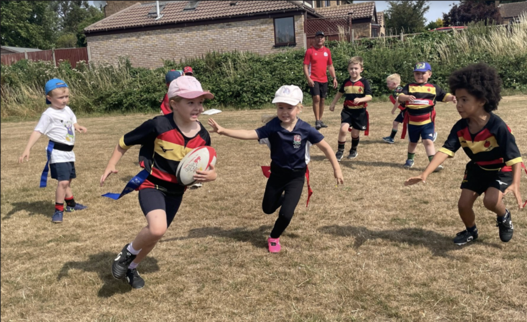 Children running, playing rugby