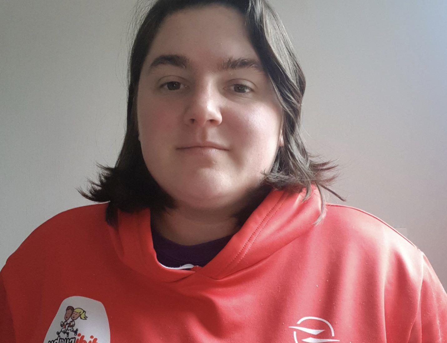 didi rugby Lichfield owner Emelie Denham wears a red didi rugby hoodie
